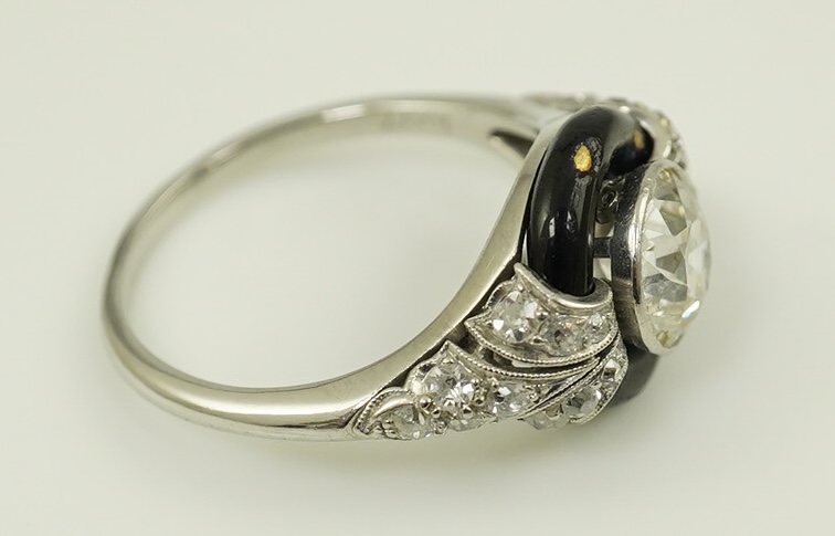 An Art Deco platinum black enamel and diamond set ring